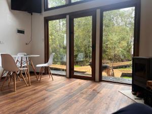 a living room with sliding glass doors and a table and chairs at Panigal in Hornopiren