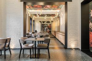 a dining room with tables and chairs and a ceiling at URBAN HOTEL in Debrecen