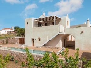 a house with a staircase leading to a pool at Casa Kombonada in Kýthira