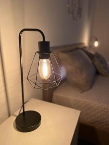 a lamp sitting on a table next to a couch at Licia's home in Palermo