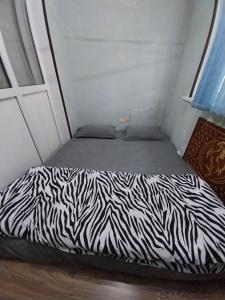 a zebra print bed in a small room at Apartment for guests in the centre of Tashkent city in Tashkent