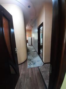 a hallway in a building with a mirror and a door at Apartment for guests in the centre of Tashkent city in Tashkent