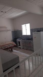 a living room with a stove and a window at Residencial Praia Quente casas in Nova Viçosa