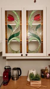 a kitchen cabinet with stained glass windows on it at Innere Stadt Apartment (am Ring) in Vienna