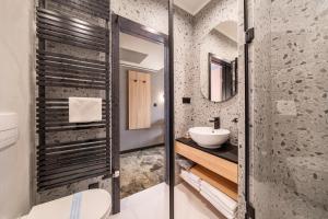 a bathroom with a toilet and a sink at URBAN HOTEL in Debrecen