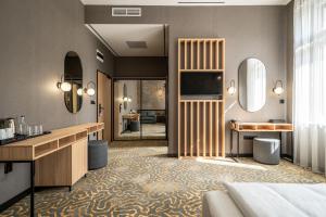 a hotel room with a bed and a bathroom at URBAN HOTEL in Debrecen
