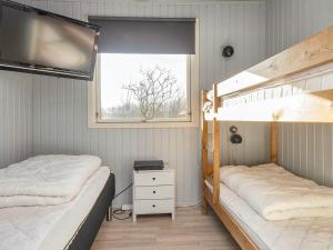 two bunk beds in a room with a window at 5 person holiday home in Ansager-By Traum in Ansager