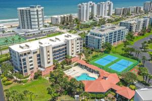 an aerial view of a resort with a tennis court at Oceanwalk 10-203 in New Smyrna Beach