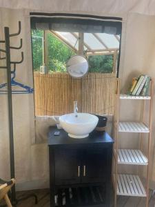 a bathroom with a sink and a mirror at Two bedroom tent on the beach private plunge pool in Matapalo
