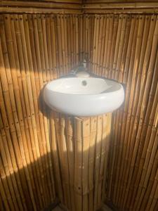 a white sink in a bamboo wall at Two bedroom tent on the beach private plunge pool in Matapalo