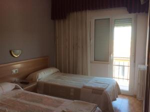 Postel nebo postele na pokoji v ubytování Hostal Juli