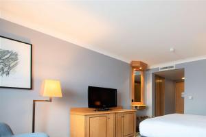 a hotel room with a bed and a television at DoubleTree by Hilton Swindon Hotel in Swindon