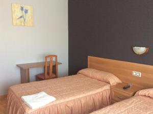 Postel nebo postele na pokoji v ubytování Hostal Juli