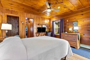 a bedroom with a white bed in a wooden room at Lakeview on the Lake in North East