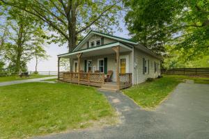 a small white house with a porch and a yard at Lakeview on the Lake in North East