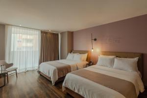 Ένα ή περισσότερα κρεβάτια σε δωμάτιο στο Sites Hotel