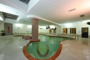 a large swimming pool in a hotel room with a pool at DoubleTree by Hilton Sarasota Bradenton Airport in Sarasota