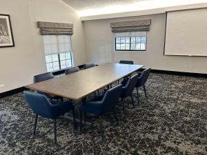 a conference room with a large wooden table and chairs at Best Western Schaumburg – O’Hare NW in Schaumburg