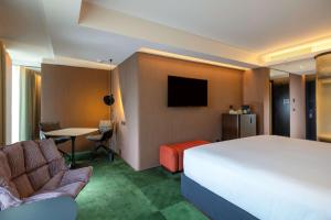 a hotel room with a large bed and a table at Doubletree By Hilton Lima San Isidro in Lima
