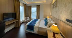 a hotel room with a bed and a television at The Woodbury in Gurgaon