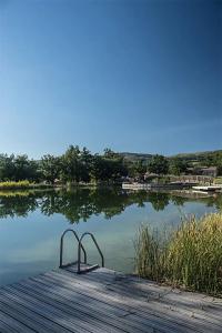 ein Metallobjekt auf einem Dock auf einem See in der Unterkunft Maisons situées dans le vaste domaine de l'espinet in Quillan