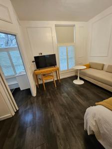 a living room with a couch and a tv at Studio in central London in London