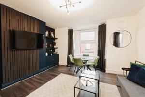 a living room with a couch and a table at Lamara Flat 2, Liverpool in Liverpool