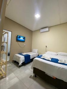 Cama ou camas em um quarto em Pousada Vista da Serra - Suzart
