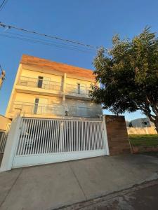 a house with a white gate in front of it at Apto novo em região nobre de Boituva in Boituva