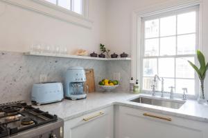 a kitchen with a sink and a counter top at Green Cottage at Casa Zoe in Charleston