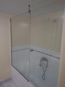 a shower with a glass door in a bathroom at Kolonaki Private Room in Athens