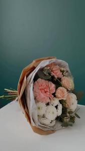 a bouquet of pink and white flowers on a table at Kolonaki Private Room in Athens