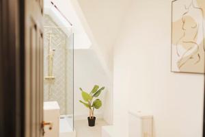 a bathroom with a toilet and a plant in it at Lamara Flat 3, Liverpool in Liverpool