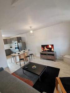 a living room with a couch and a table at Appartement Spacieux 80 m2 in Bobigny