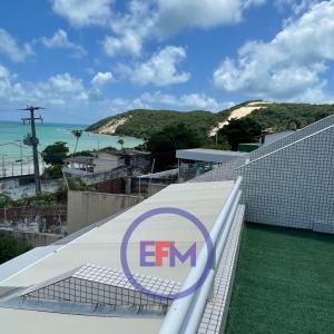 a view of the emm logo on top of a building at Varandas - Apartamentos in Natal