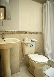 a bathroom with a toilet and a sink at BEAUTIFUL, SPACIOUS & COZY HOUSE LOCATED IN THE HEART OF CUSCO in Cusco
