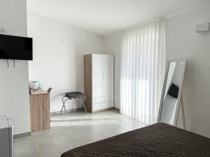 TV a/nebo společenská místnost v ubytování Valle degli Ulivi B&B