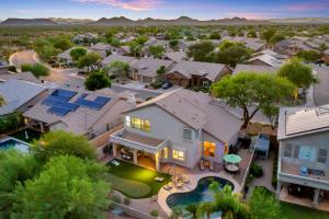 an aerial view of a home with a pool at Pool, Putting Green, Arcade, Cornhole, Great Location at Phoenix Desert Ridge Retreat! in Phoenix