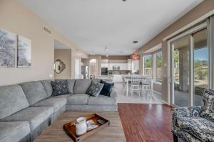 a living room with a couch and a table at Pool, Putting Green, Arcade, Cornhole, Great Location at Phoenix Desert Ridge Retreat! in Phoenix