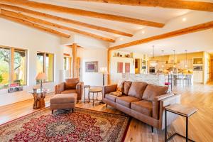 a living room with a couch and a table at Scottsdale Agave House- Located on one Acre, Resort Style Amenities and Private Casita! in Scottsdale