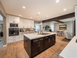 a large kitchen with white cabinets and a large island at Great Location Near Local Bars & Museums and Private Patio- Phoenix Casa GQ in Phoenix