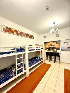 a room with two bunk beds and a table at Dubai Backpackers in Dubai