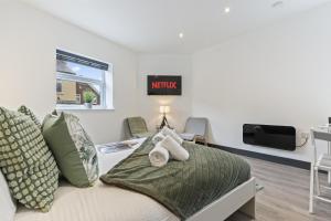 a bedroom with a bed with a tv on the wall at Free Parking Ideal for solo business travellers in Ilkeston