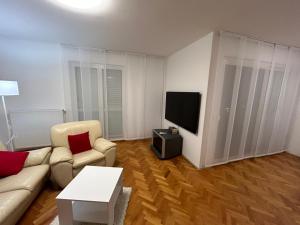 a living room with a couch and a tv at Apartment Tina in Rijeka