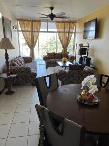 a living room with a table and a couch at Worthington Towers Apartment in Kingston