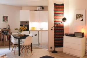 a kitchen and a dining room with a table and a kitchen at Charming and practical studio in Paris 14th in Paris