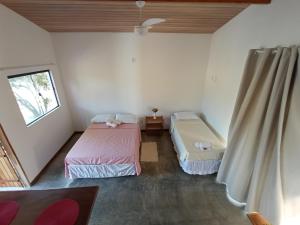 Flor e Luz Chalés客房内的一张或多张床位