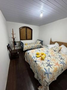 a bedroom with a bed and a cross on the wall at Casa da Vovó Irene in Araruama