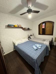 a bedroom with a bed with two towels on it at Casa da Vovó Irene in Araruama