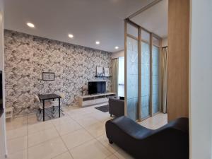 a living room with a couch and a television at The Robertson Residences at Bukit Bintang Kuala Lumpur by Autumn Suites Premium Stay in Kuala Lumpur